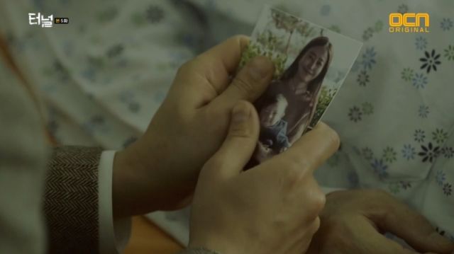 Seon-jae holding a picture of him and his mom